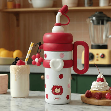 A colourful red insulated thermos flask with red cartoon cherry patterns on a kitchen counter with a milkshake and desert