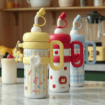Three colourful children's thermos bottles with cartoon designs on a kitchen counter.