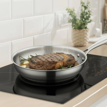German Stainless Steel Hammered Non-Stick Pattern frying pan with steak on a modern kitchen stove