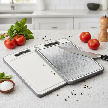 Two cutting boards on a kitchen counter with tomatoes and a knife.