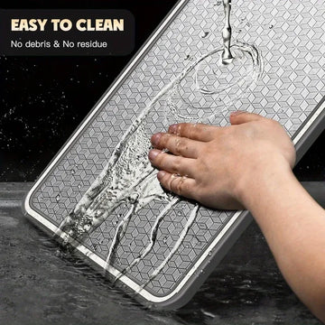 Person washing a mat with soap and water, text 'Easy to clean, no debris & no residue' above.