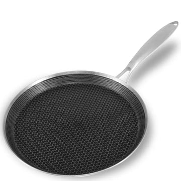 stainless steel hexclad honeycomb non-stick crepe pan 26cm on a kitchen worktop with cooking ingredients